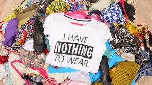 Pile of clothing on the floor with a shirt that says "I Have Nothing to Wear"